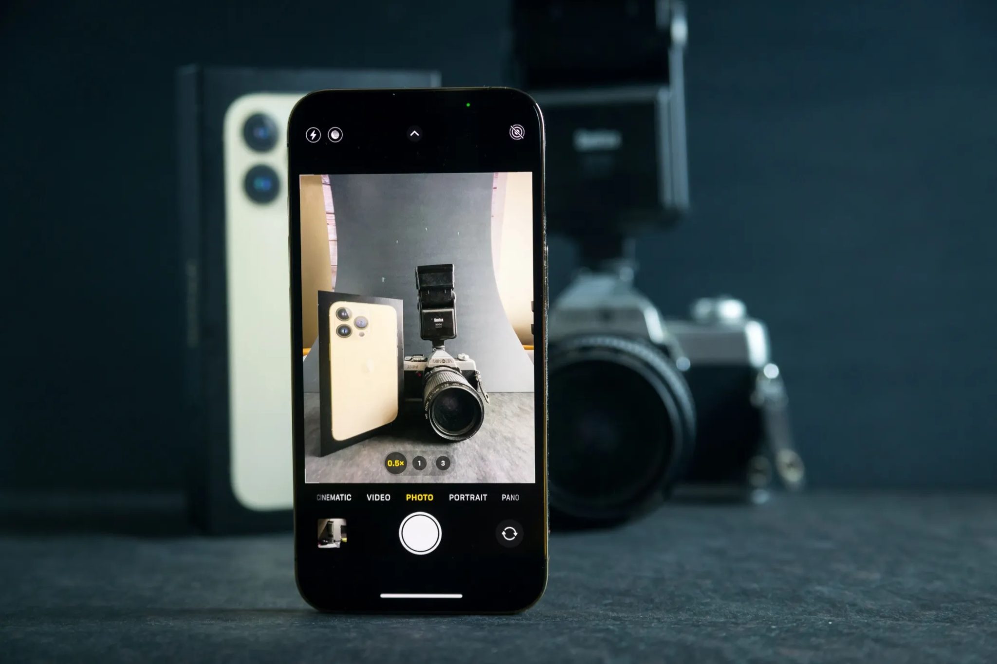 Fotografie zbrusu nového iPhone 13 s aplikací fotoaparátu Vytvořte fotografii Mirror méně fotoaparátu a iPhone 13 oficiální krabice.